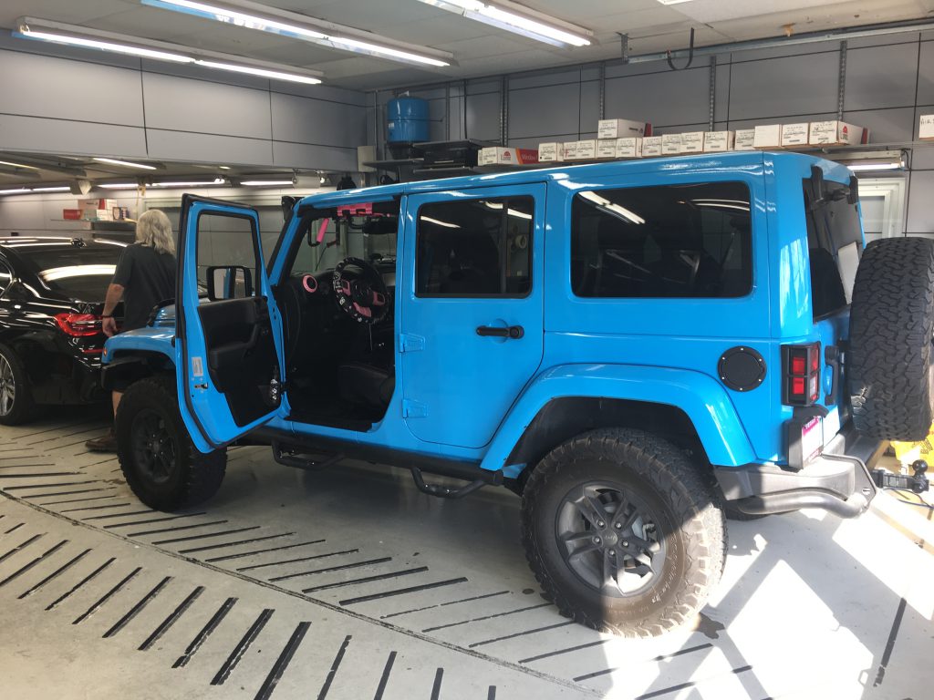 Baby blue jeep with window tinting